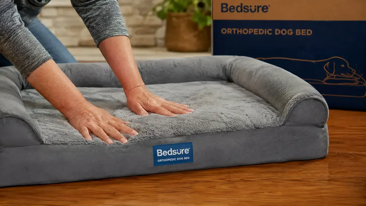 Close-up of a hand pressing into thick orthopedic foam of the Bedsure dog bed, showing the dense supportive base