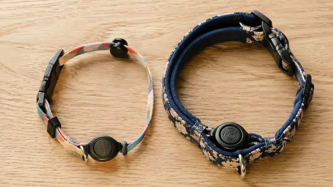 Cat collar laid flat showing the RFID sensor tag attached, demonstrating how the tag sits on a thin breakaway collar versus a thick padded one